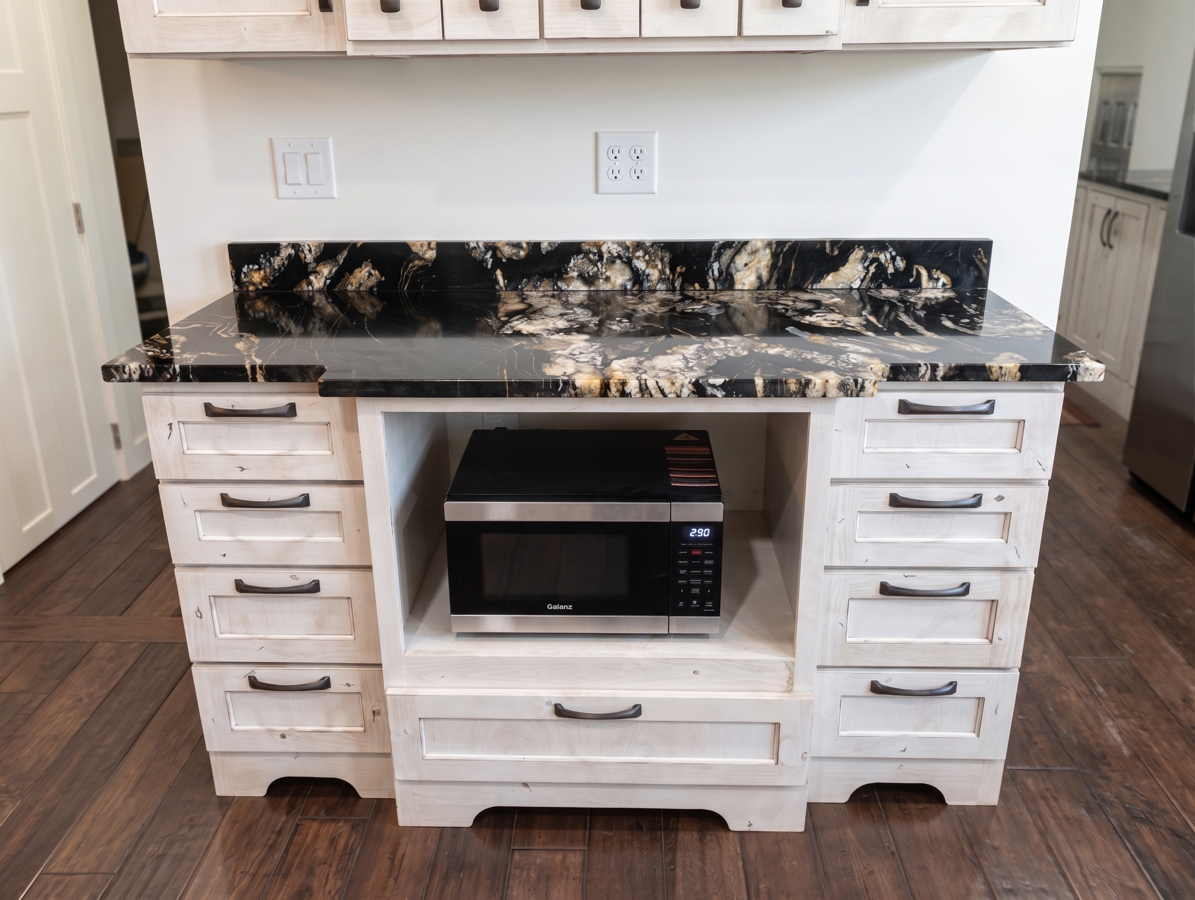 Kitchen with black-and-gold granite and a custom hutch
